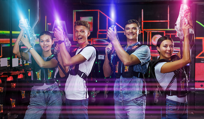 People With Neon Lights In Hand, Playing Laser Tag With Laser Gun Equipment