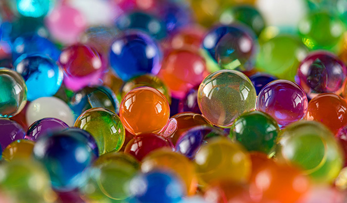 Colorful marbles close up, used in Gel Blaster Games with gel pellets for shooting sport