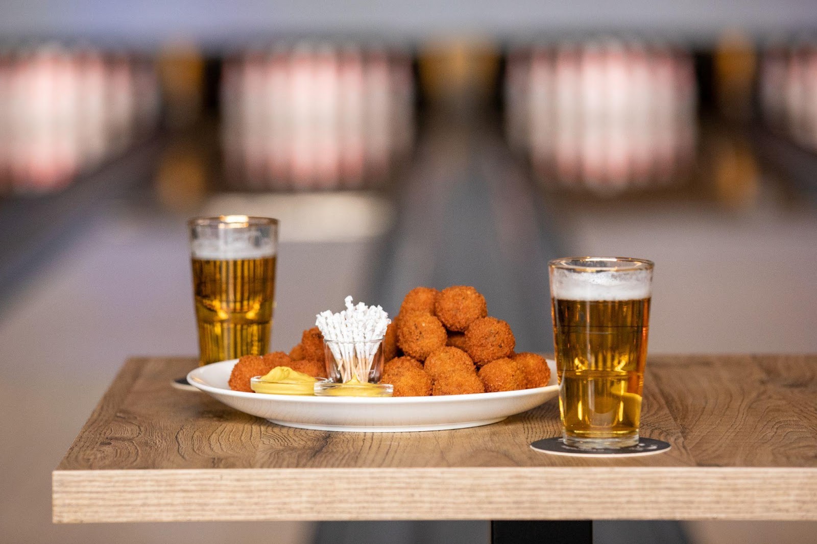 Fried chicken and beer on a bowling lane