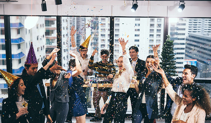 A group of people celebrating at a company party, enjoying the festive atmosphere
