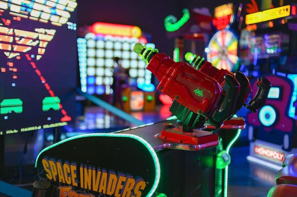 A colorful game machine with neon lights designed to attract players