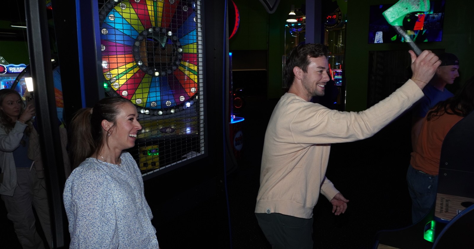 employee appreciation ideas ogden Two coworkers laughing and celebrating at an arcade game at Skinny Dogz in Ogden